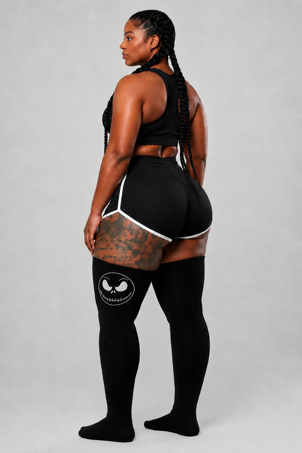Plus size thigh high socks with smiling nightmare face graphic in dark colors