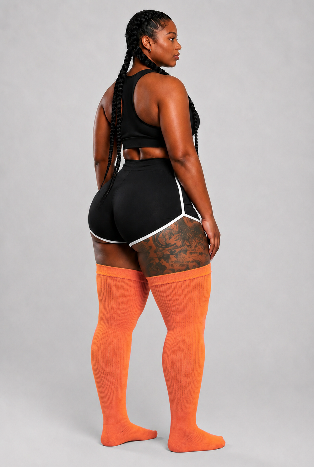 Plus size thigh high socks in warm orange, pink, and yellow sunset gradient