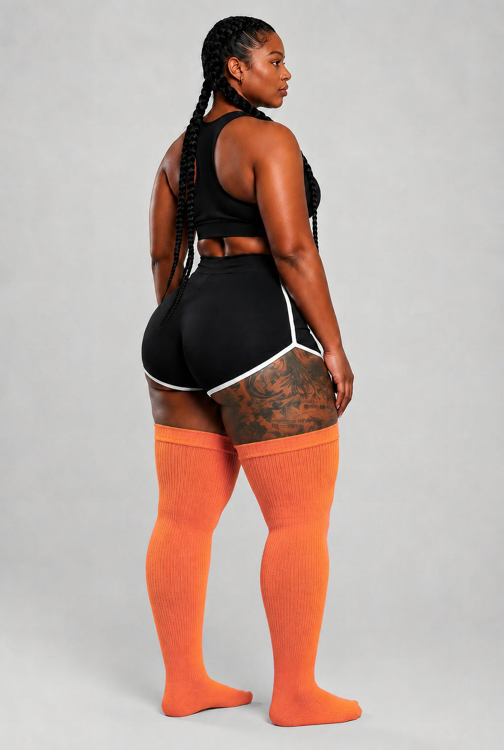 Plus size thigh high socks in warm orange, pink, and yellow sunset gradient