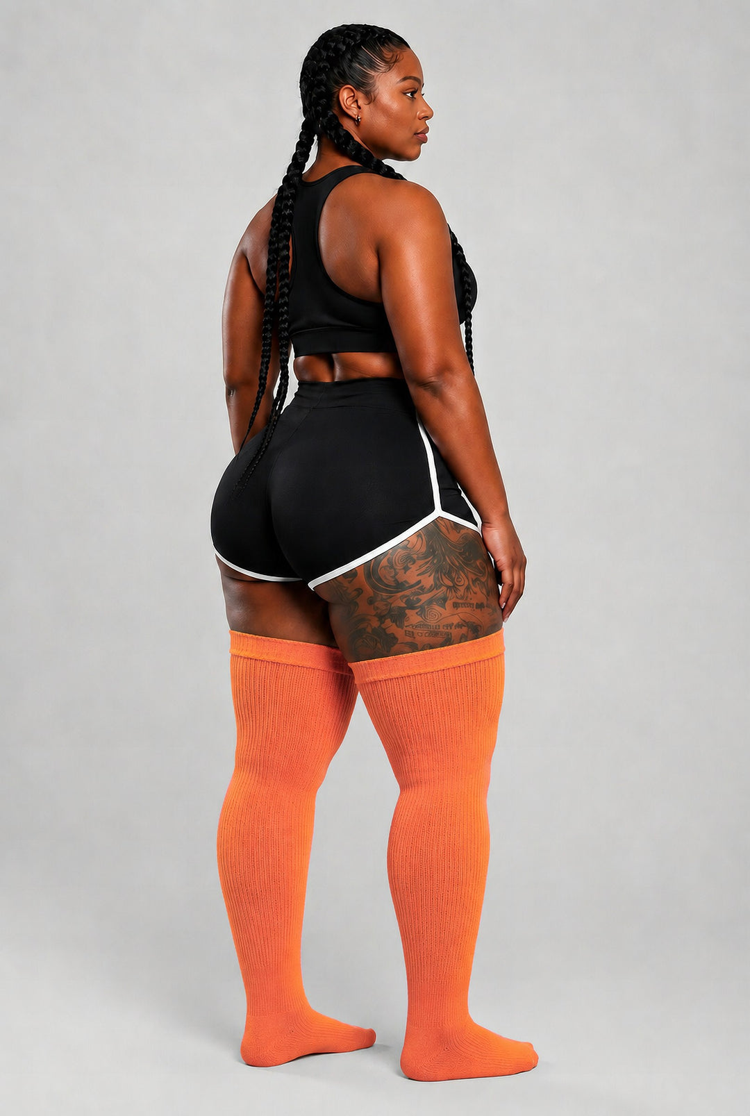 Plus size thigh high socks in warm orange, pink, and yellow sunset gradient