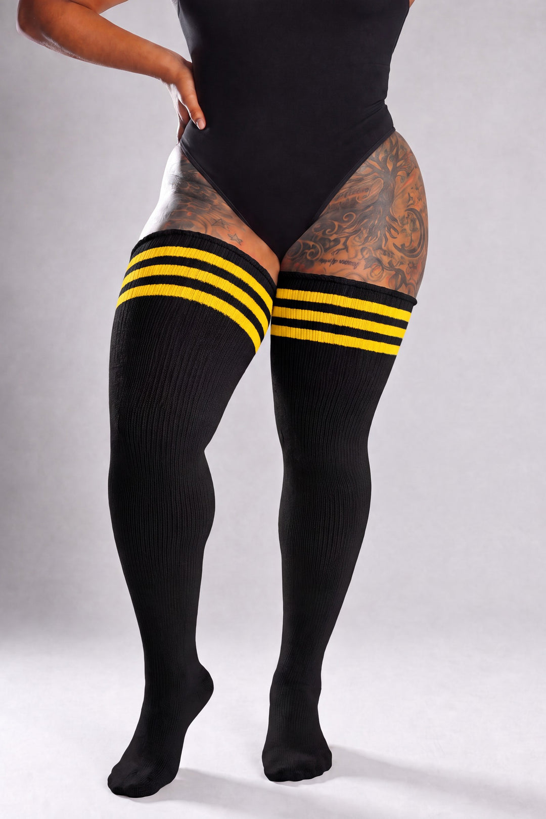 Plus size thigh high socks in sunset gradient of orange, pink, and purple