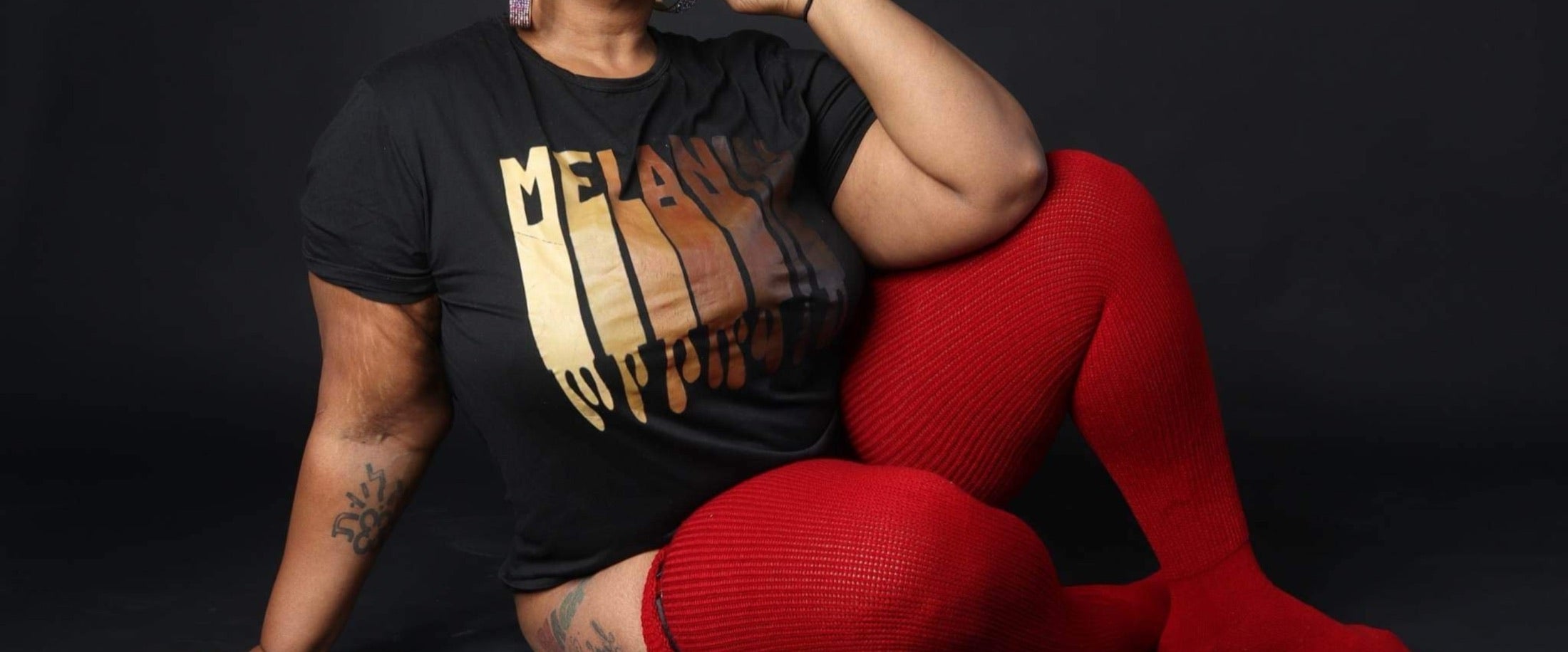 Plus-size model wearing Thick Thigh Tribe solid thigh-high socks